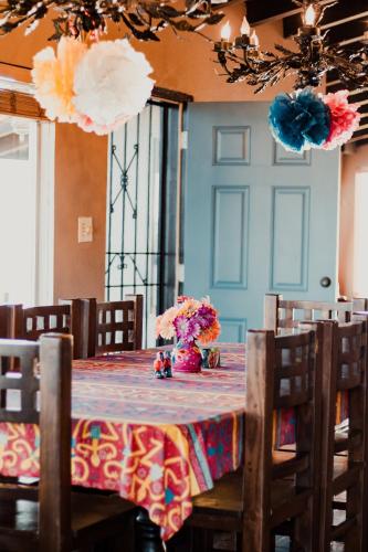 a dining room table with a vase of flowers on it at Su Casa in Ensenada