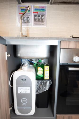 a drawer in a kitchen with a sink and a toilet at Maison SINDBAD in Pero