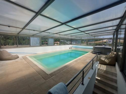 a swimming pool in a house with a roof at Fonte Seca GuestHouse in Leiria