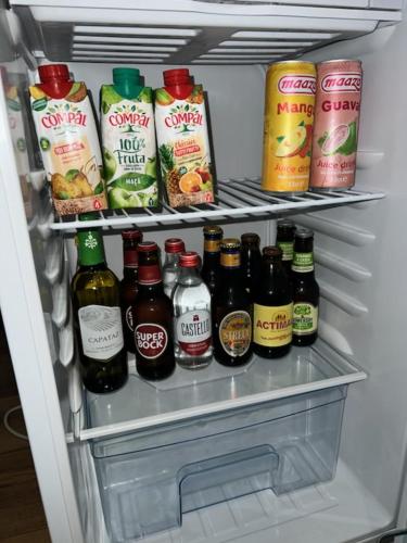 a refrigerator filled with lots of drinks and condiments at Techas City Center Luxurious Suites & Rooms in Praia