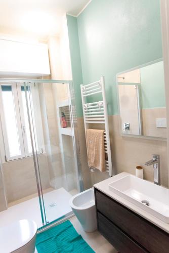 a bathroom with a sink and a toilet and a shower at Maison SINDBAD in Pero