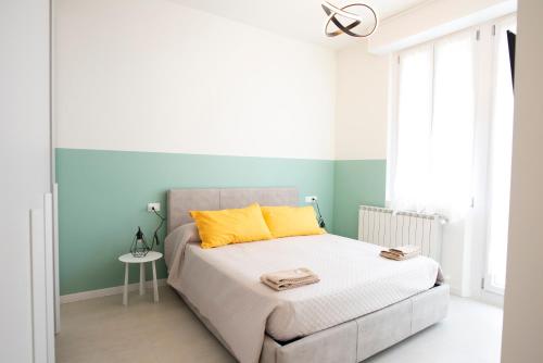 um quarto com uma cama com almofadas amarelas em Maison SINDBAD em Pero
