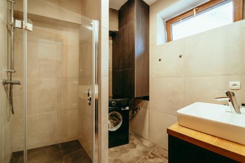 a bathroom with a sink and a washing machine at Luxury style apartment in Šaštín