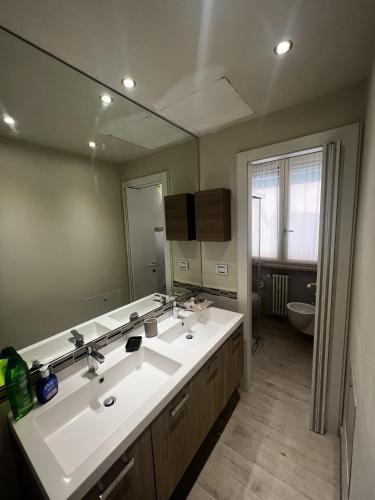 a bathroom with two sinks and a large mirror at Room Verona Mamma Bianca in Verona