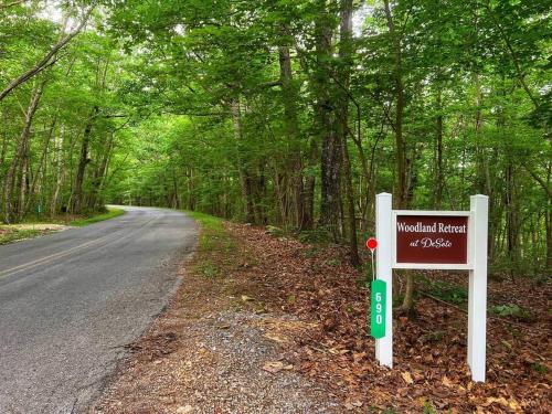 a sign on the side of a road at The Otter Box Cabin - 92 Acres Beside DeSoto State Park in Fort Payne