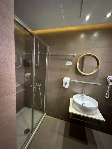 a bathroom with a shower and a sink at StelSif Studio's in Atsipopoulo