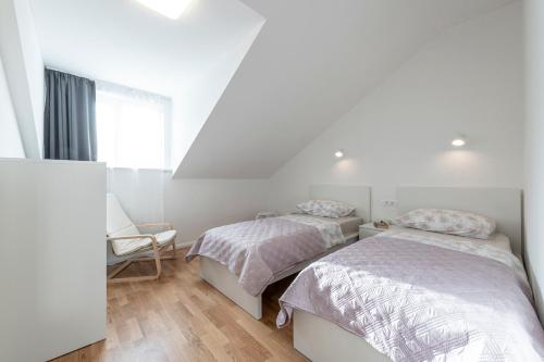 a bedroom with two beds and a window at Apartment Meri in Dubrovnik