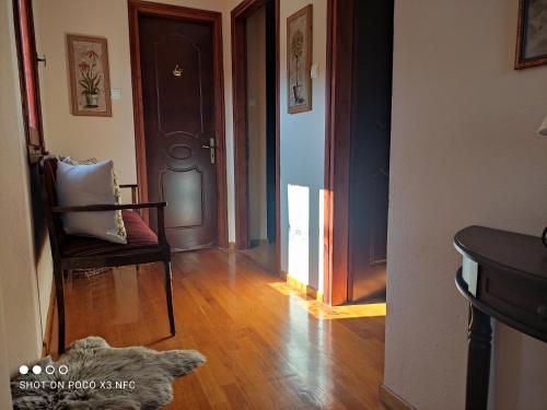 a hallway with a door and a dog laying on the floor at MESONISI maisonette in Afissos