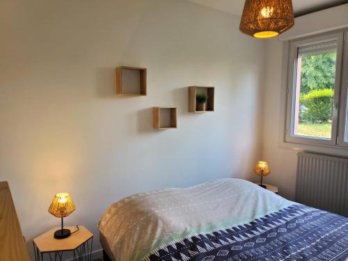 a bedroom with a bed and two lamps and a window at Sweet appartement entier Metz Sablon Gare 75 m2 in Metz