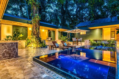 an exterior view of a house with a swimming pool at The Oasis at Puket in Manzanillo