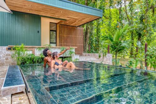 two women sitting in the water in a swimming pool at The Oasis at Puket in Manzanillo