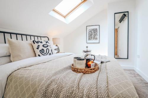 a bedroom with a bed with a tray on it at Principality View Apartment Three, by Solace Stays in Cardiff