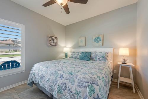 a bedroom with a bed and a ceiling fan at Bonnie Dune in Port Aransas
