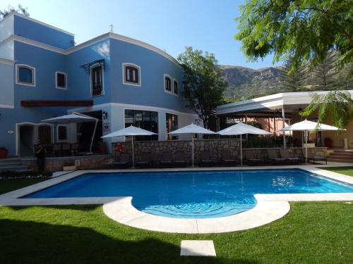 a swimming pool in front of a house at Villa Maria Cristina Hotel in Guanajuato