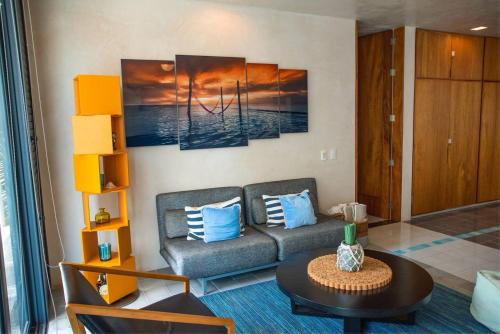 a living room with a couch and a table at Apartamento en el corazón de Playa del Carmen, Sabor a Miel in Playa del Carmen