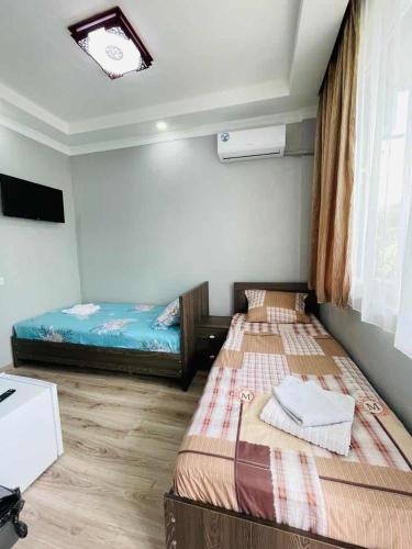 Ένα ή περισσότερα κρεβάτια σε δωμάτιο στο New Batumi