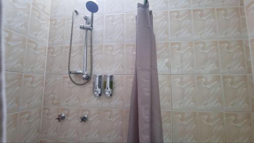 a shower in a bathroom with a shower head at Hotel Asturias in Viña del Mar