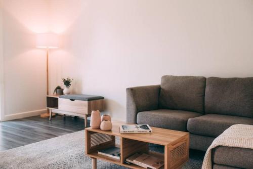 a living room with a couch and a coffee table at The Vine House - Benalla in Benalla