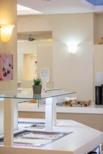a glass table with a potted plant on top of it at Bali Beach and Sofia Village in Balíon