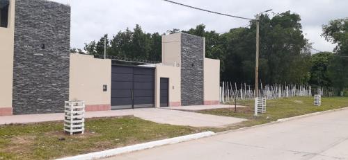 a building with black doors on the side of a street at El Solar Departamentos Tartagal in Tartagal