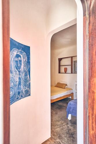 a room with a painting of a woman on the wall at Casa Love in Sayulita