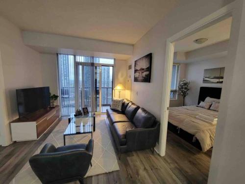 a living room with a bed and a couch at City Centre Lodge ( Downtown) in Mississauga