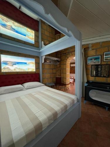 a bedroom with a large bed and a piano at Villa Sofia in Lampedusa