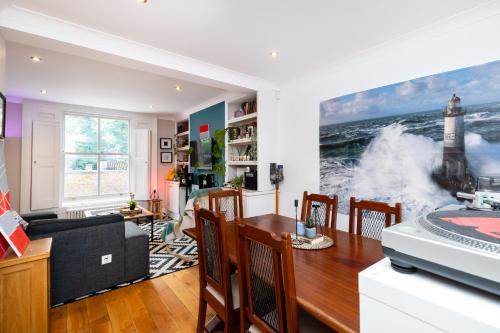 a living room with a table and a dining room at Double Room with TV and Garden Hot Tub in London