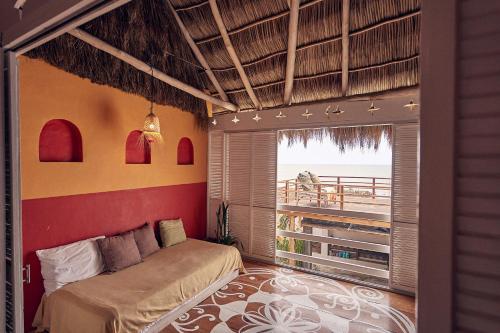 a bedroom with a bed and a view of the ocean at Casa Love in Sayulita