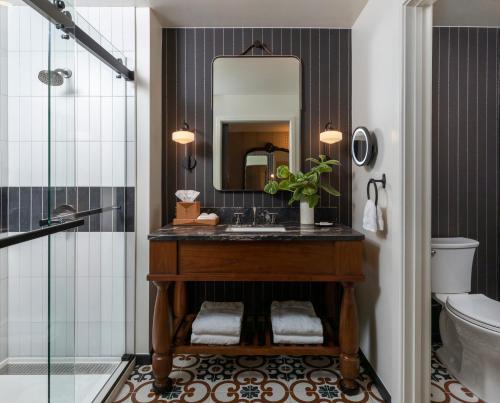 a bathroom with a sink and a mirror at Estancia La Jolla Hotel & Spa in San Diego