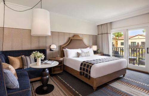 a hotel room with a bed and a couch at Estancia La Jolla Hotel & Spa in San Diego