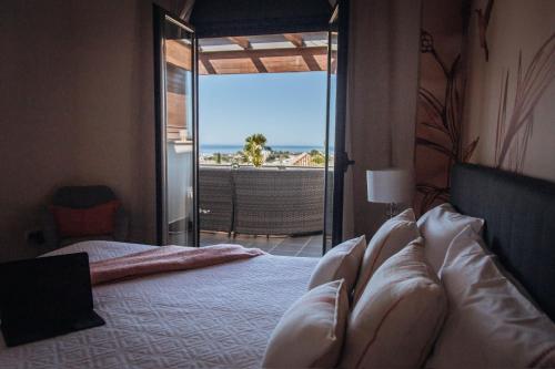 a bedroom with a bed with a view of the ocean at Luxury apartment with panoramic views - Marbella in Estepona