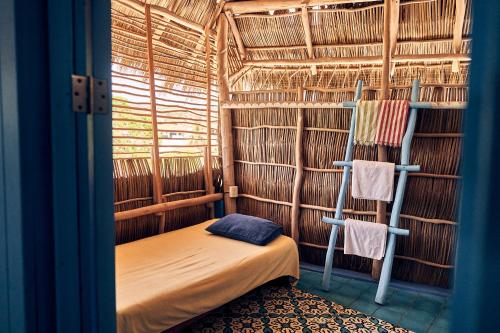 a small room with a bed and two bunk beds at Casa Love in Sayulita