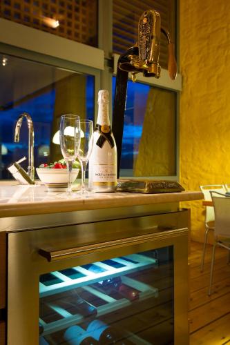 a bottle of wine sitting on top of a kitchen counter at Athina Epavlis - Ethereal Charm of Blue Horizons in Ravdhoúkha