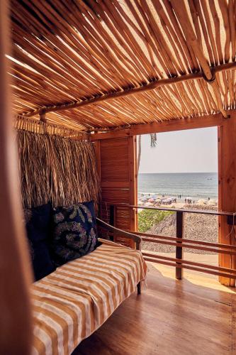 a bed in a room with a view of the beach at Casa Love in Sayulita