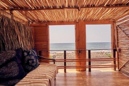 a room with a bed and a view of the ocean at Casa Love in Sayulita