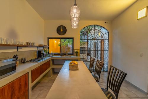 a kitchen with a table and chairs and a window at Casa Madero La Paz in La Paz