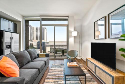 a living room with a couch and a flat screen tv at Kasa Lady Bird Lake Austin in Austin