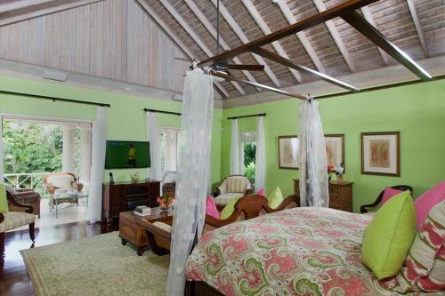 a bedroom with a bed and a living room at Sunny Vacation Villa No 5 in Montego Bay