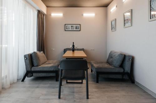 a waiting room with two chairs and a table and chairs at The SPOT apartments - Orbi Beach Tower in Batumi