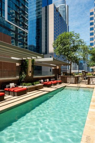 a swimming pool with red benches and some buildings at Kasa Lady Bird Lake Austin in Austin