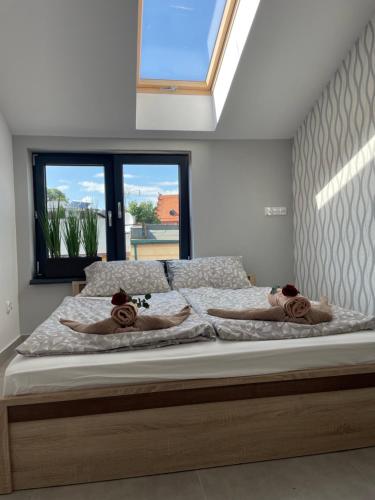 a bedroom with a bed with two teddy bears on it at Apartament I w Centrum - Winda - 50 metrów od Starego Rynku in Kościerzyna
