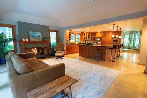 a living room with a couch and a fireplace at Bridle Trails Treehouse in Bellevue