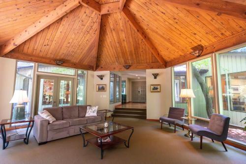 a living room with a couch and a table at Bridle Trails Treehouse in Bellevue