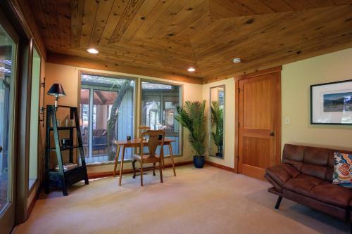 a living room with a wooden ceiling at Bridle Trails Treehouse in Bellevue