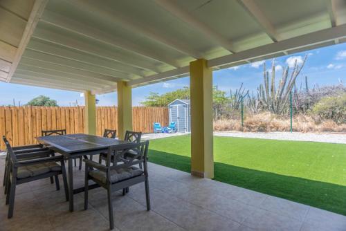 a patio with a table and chairs and a yard at NEW ! Casa Orcuyo in Santa Cruz
