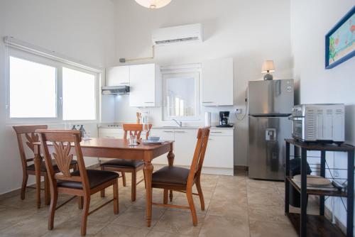 a kitchen with a table and chairs and a refrigerator at NEW ! Casa Orcuyo in Santa Cruz