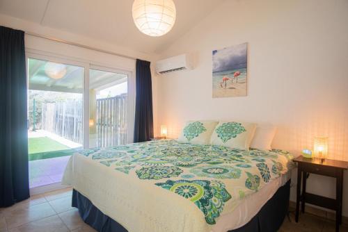 a bedroom with a large bed and a large window at NEW ! Casa Orcuyo in Santa Cruz