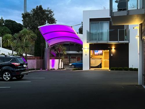 a car parked in a parking lot next to a building at The Sails Nelson in Nelson