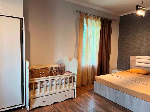 a bedroom with a bed and a baby crib at Awesome Large 3 Floor Villa Dilijan , 8 Bedrooms+4.5 Bathrooms+Swimming Pool, Nice Mountain View in Dilijan